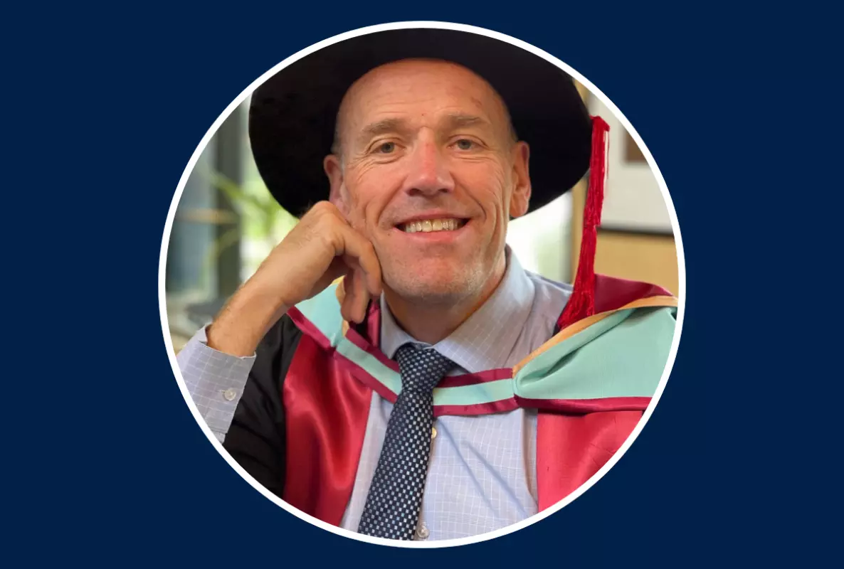 Headshot of man in academic dress